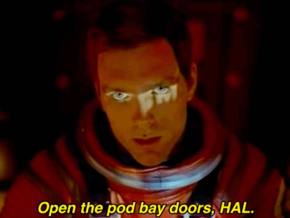Keir Dullea as David Bowman in 2001: A Space Odyssey with the text 'Open the pod bay doors, HAL'